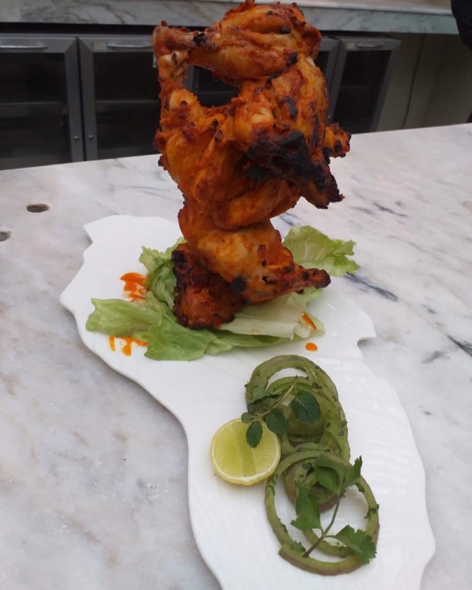 Tandoori chicken presented as a tower