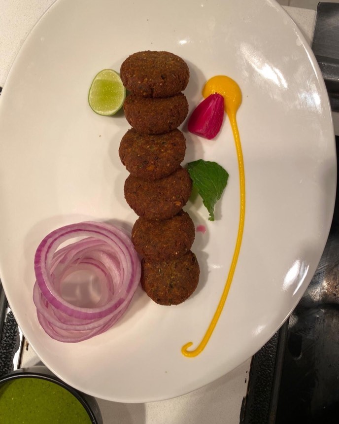 Stack of shami kebabs with onion rings